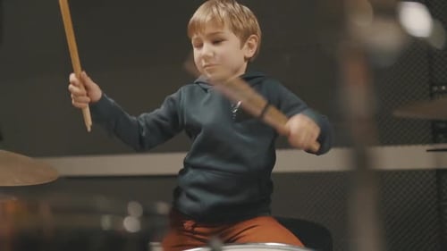 Enthusiastic Boy Plays Drums in Music Studio