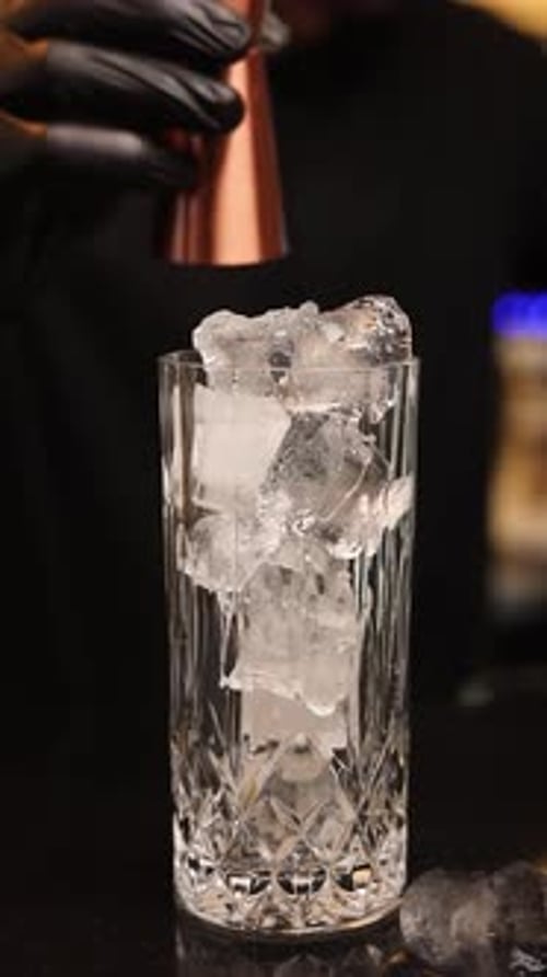 the bartender at the bar prepares alcoholic cocktails