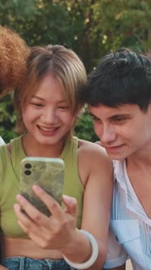 Front view of conversation between three friends on the street