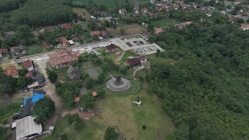 Aerial View Of A Serene Village Landscape With Trees And Buildings