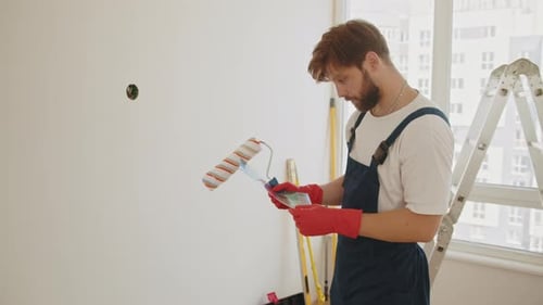 Man Chooses Paint Color in Apartment