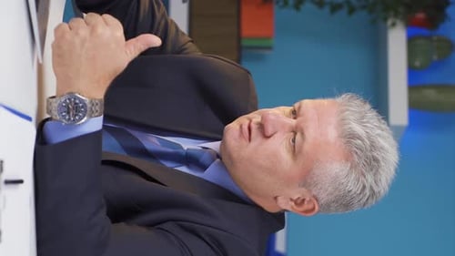 Businessman Explaining Concept at Table Indoors