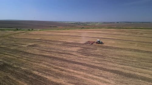 Tractor working on the field doing tillage with cultivator