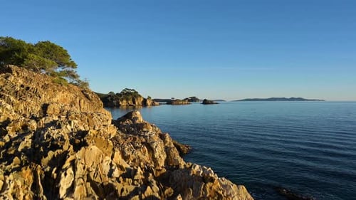 The beautiful weathered rocky mountain coastline near the Saint-Tropez, French Riviera - crane shot