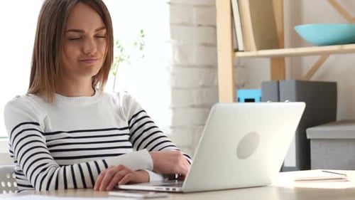 Young Woman Works on Laptop in Home Office