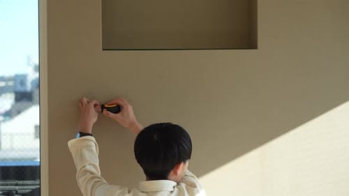 A man measuring the room with a tape measure