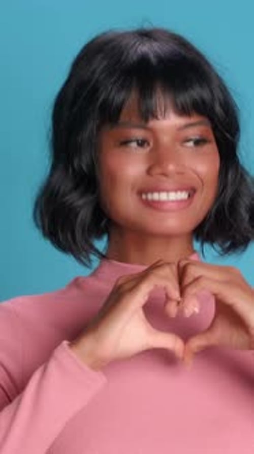Woman Makes Heart Shape Gesture