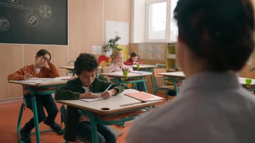 Back View Unrecognizable Female Teacher Woman Tutor at School Class Lesson Teach Children Elementary