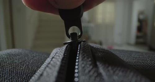Macro Video of a Zipper Closing a Bag Clasp