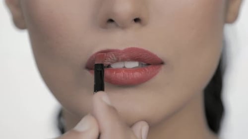 Adult Applying Red Lipstick with Lip Liner Brush