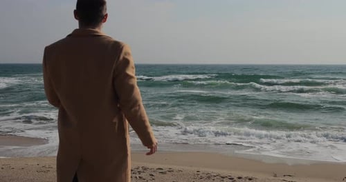 A Man in a Coat Looking at the Sea Slow Motion