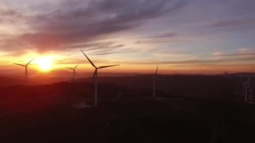 Scenic Aerial view of wind turbines farm in sunset time. High quality 4k footage