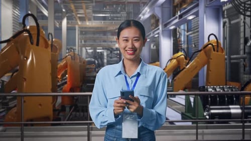 Woman Using Smartphone at Futuristic Factory Workplace