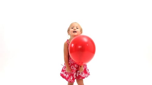 Blonde Girl Plays with Red Balloon in Studio