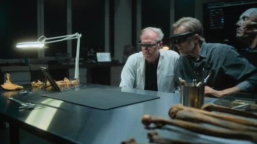 Men in AR Glasses Analyzing Bones in Dark Lab