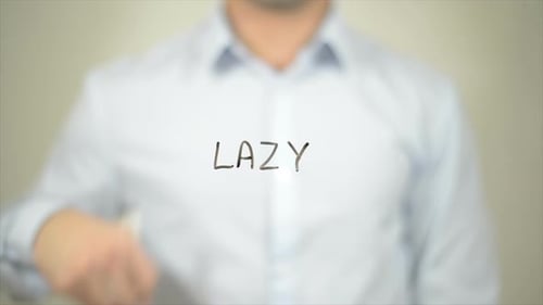 Hand Writes 'Lazy' with Marker, Close Up