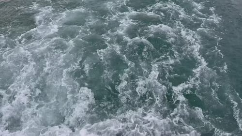 Cinematic Close-Up of Turbulent Boat Wake and White Foam on Ocean