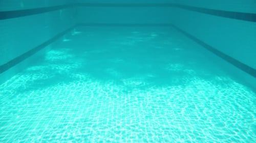Blue swimming pool, underwater shooting, sunny day.