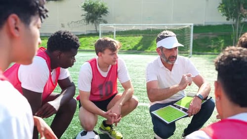 Soccer Coach Explaining Game Strategy to Young Players