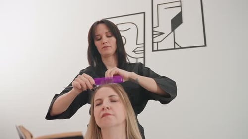 Woman Getting Hair Styled at a Hair Salon