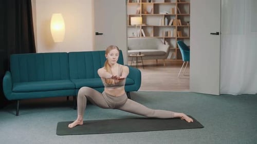 Woman Practicing Yoga and Stretching in Her Home