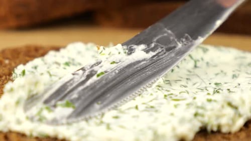 Brown Bread Covered in Creamy Herb Spread