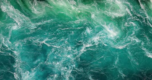 Blue waves of water of the river and the sea meet each other during high tide and low tide.