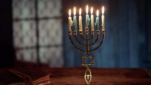 Hanukkah Menorah with Burning Candles on Table