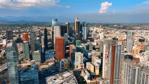 Flying above the high-rise architecture of modern city downtown. Scenic view of vibrant Los Angeles