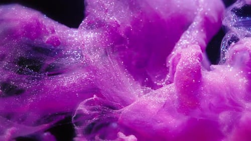 Real Ink Swirl with Sparkling Particles on Black Background