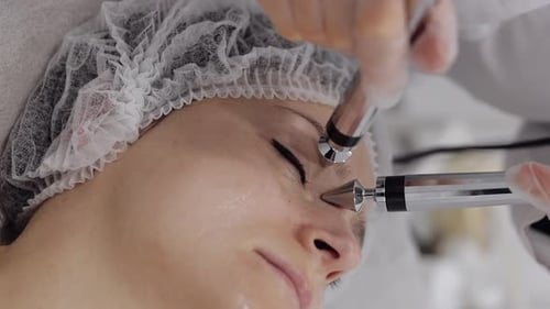 Middleaged Woman Receiving Micro Currents Facial Eyes Skin Treatment From Beautician in Spa Salon
