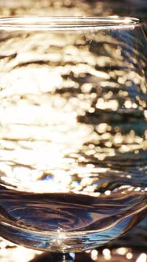 Golden Light Reflecting in a Stemmed Glass