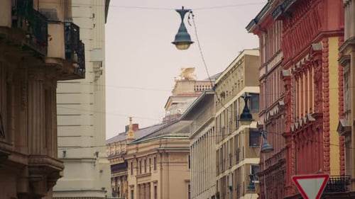 Urban street lined with historic buildings showing everyday city life and classic architecture