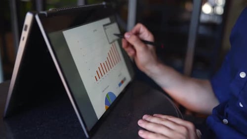 Close Up of Adult Analyzing Data