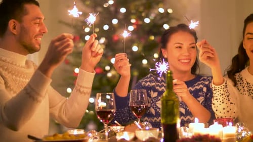 Friends celebrate with sparklers at Christmas dinner