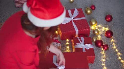 Woman Wrapping Christmas Presents at Home