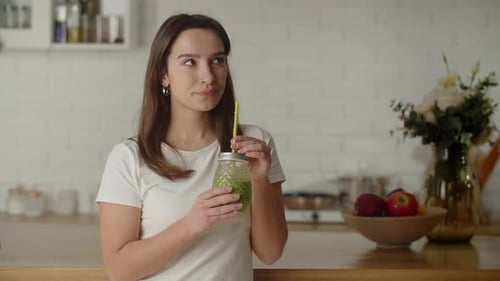 View of a Vegetarian Woman Drinking Cucumber Juice Through a Straw Beautiful Brunette Enjoying