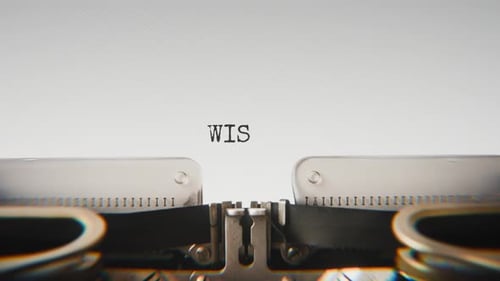 Old mechanical typewriter typing Wisdom in a close-up view.