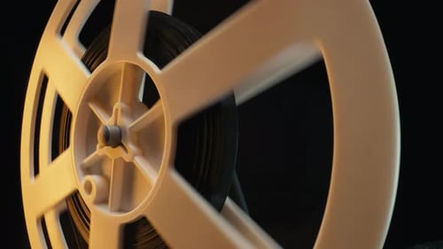 Film Reel Spinning in Golden Light