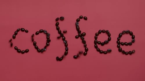 Text Coffee made from Roasted Coffee beans blowing out on pink top view