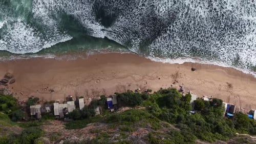 Breathtaking Aerial View of Crashing Waves on a Tropical Beach