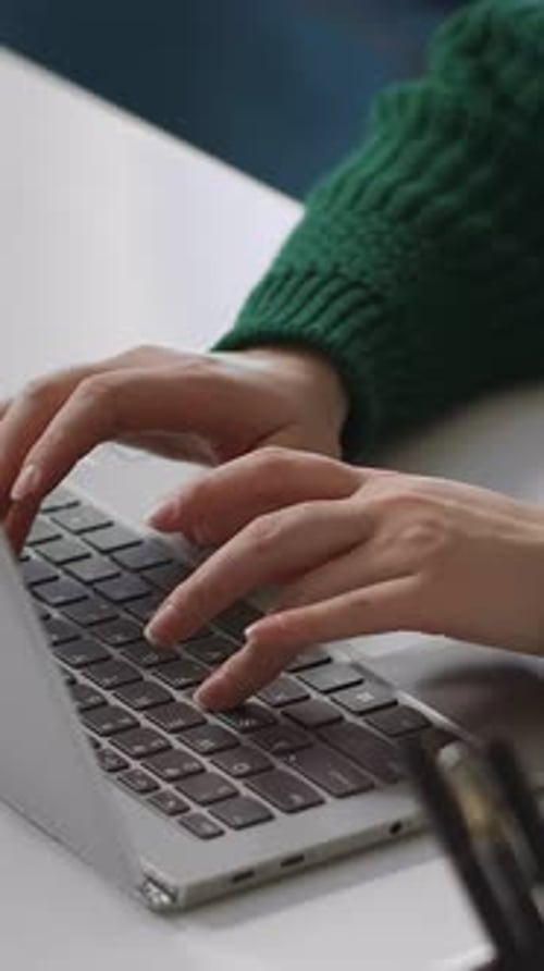 Closeup Views of Hands Typing on a Laptop Keyboard Showcasing Focused Computer Work Digital