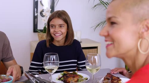 Smiling Child Having Lunch with Family and Friends