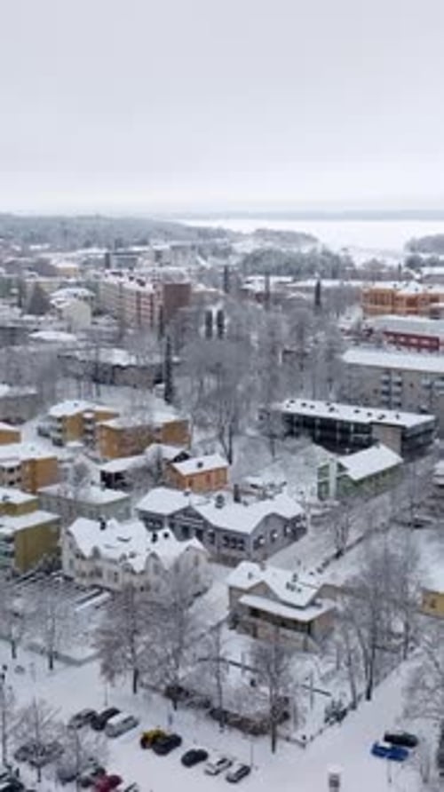 Vertical drone shot of the city of Savonlinna, cloudy, winter day in Finland