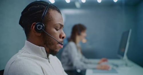 Close Up Portrait of African American Technical Support Specialist in Headset Consulting Client