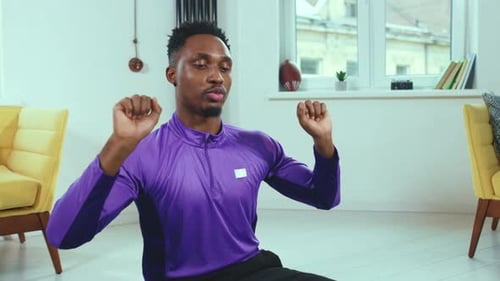Young Adult Demonstrates Workout Routine on Yoga Mat