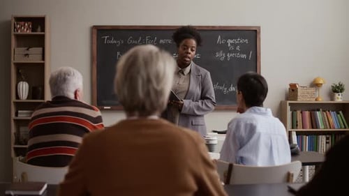 Instructor Teaches Computer Class to Mature Adult Students