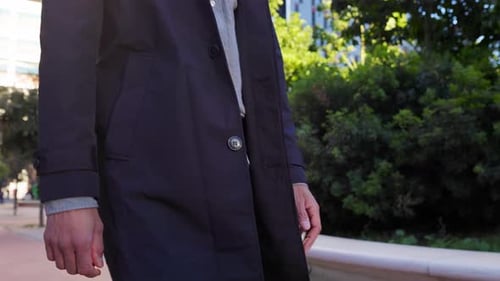 Unrecognizable Man Walking Down the City Street