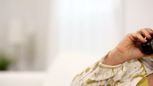 Senior Woman Smiling While Talking on Cordless Phone