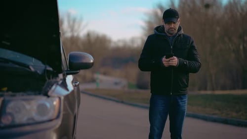Man with Car Trouble Uses Smartphone